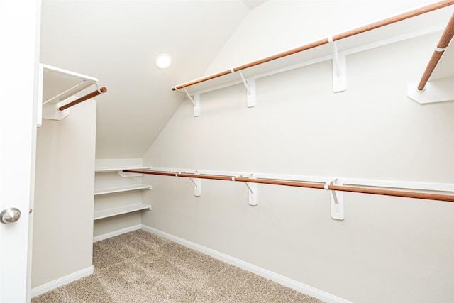 spacious closet with light carpet and lofted ceiling