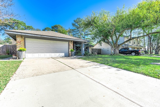 ranch-style house featuring a garage and a front yard