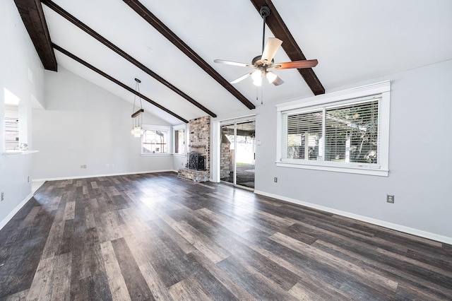 unfurnished living room featuring beamed ceiling, ceiling fan with notable chandelier, a brick fireplace, and dark wood-type flooring