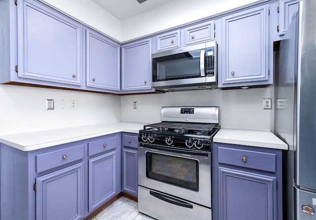 kitchen with light tile patterned floors and stainless steel appliances