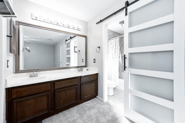 bathroom featuring vanity, toilet, and ceiling fan