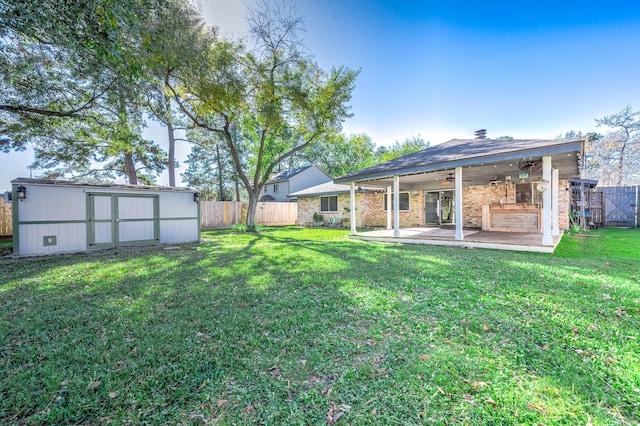 view of yard featuring a patio, a shed, and ceiling fan