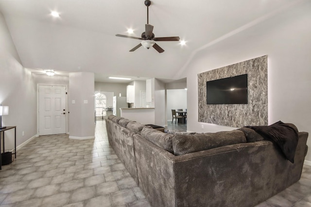 living room featuring ceiling fan and lofted ceiling