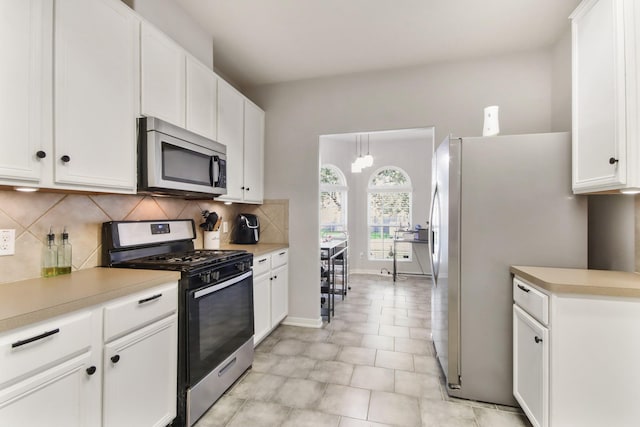 kitchen featuring white cabinetry and appliances with stainless steel finishes