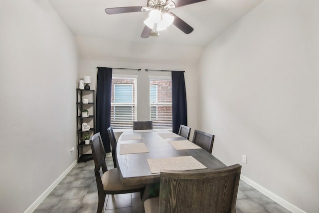 dining space with ceiling fan and lofted ceiling