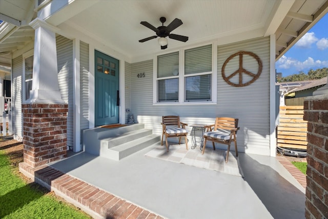 entrance to property with ceiling fan and covered porch