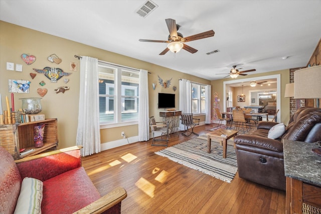 living room featuring ceiling fan and light wood-type flooring