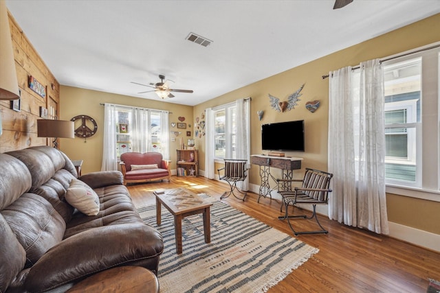 living room with hardwood / wood-style flooring and ceiling fan