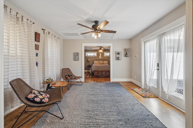 sitting room featuring ceiling fan and hardwood / wood-style floors