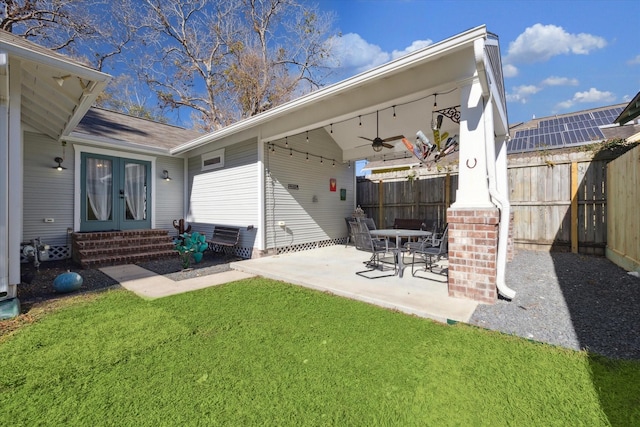 back of house with a yard, ceiling fan, french doors, and a patio