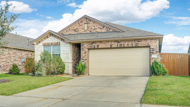 view of front of house featuring a garage and a front lawn