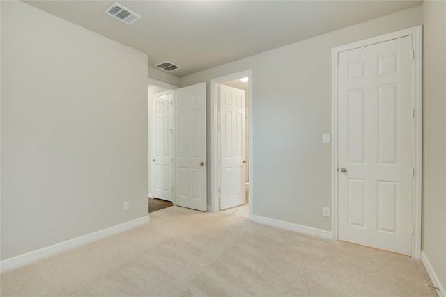 unfurnished bedroom featuring light colored carpet