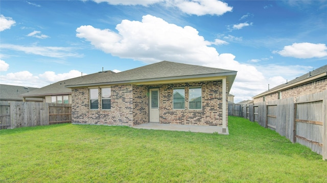 rear view of house with a yard