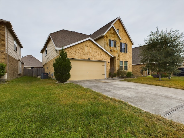 view of front of house with a front yard, central AC unit, and a garage