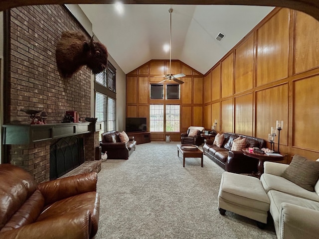 living room with ceiling fan, a fireplace, carpet, and high vaulted ceiling