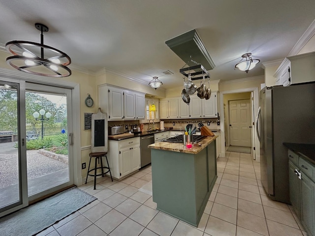 kitchen with backsplash, white cabinetry, stainless steel appliances, and ornamental molding