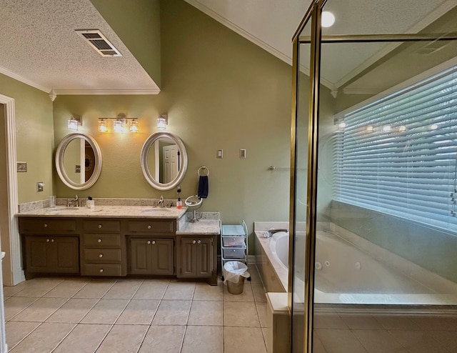 bathroom featuring vanity, a bathing tub, tile patterned floors, ornamental molding, and a textured ceiling