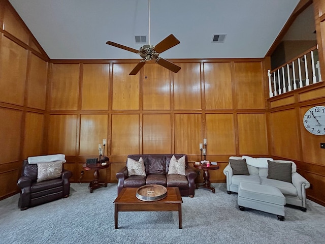 carpeted living room featuring ceiling fan and vaulted ceiling