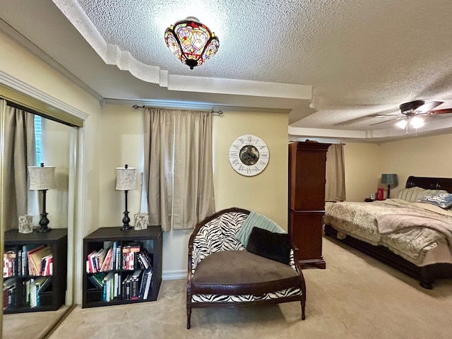 bedroom featuring carpet flooring, ceiling fan, and a textured ceiling