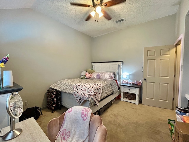 bedroom with a textured ceiling, ceiling fan, light carpet, and lofted ceiling