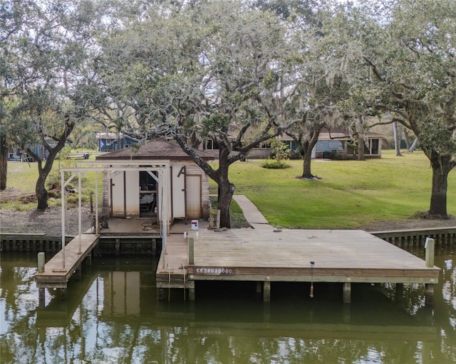 dock area featuring a lawn and a water view