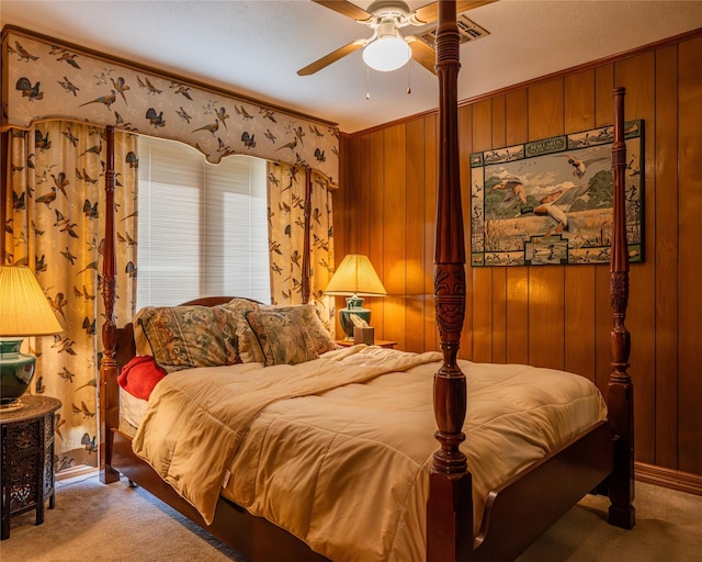 carpeted bedroom with crown molding, ceiling fan, and wooden walls