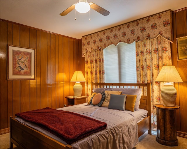 bedroom featuring carpet floors, ceiling fan, and wooden walls