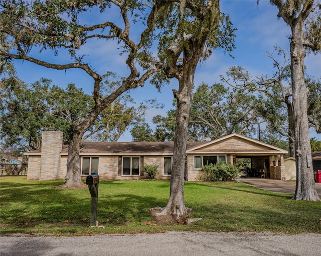 ranch-style home with a carport and a front lawn