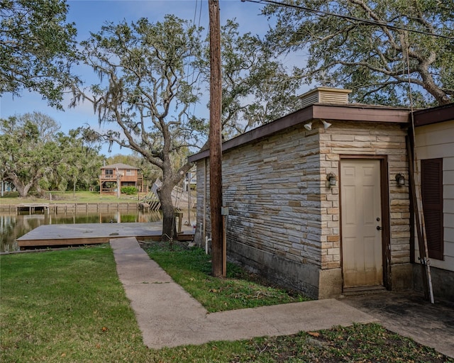 exterior space with a yard and a water view