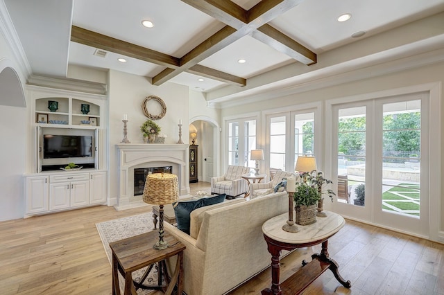 living room with beam ceiling, light wood-type flooring, and coffered ceiling