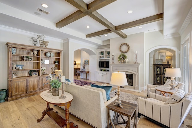 living room with beamed ceiling, light wood-type flooring, built in features, and coffered ceiling