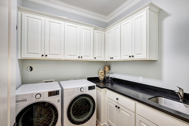 laundry room featuring washer and clothes dryer, sink, cabinets, and ornamental molding