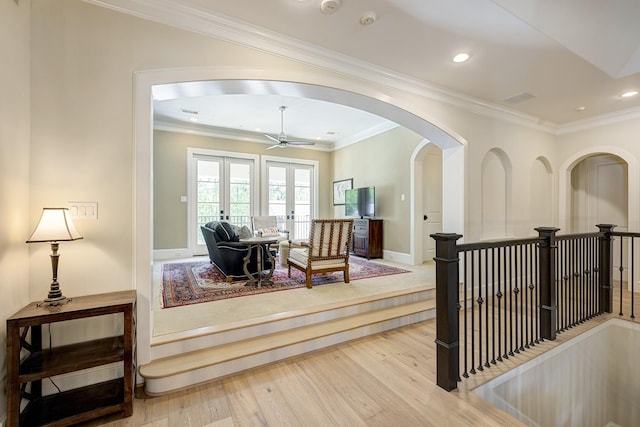 corridor featuring hardwood / wood-style floors, ornamental molding, and french doors