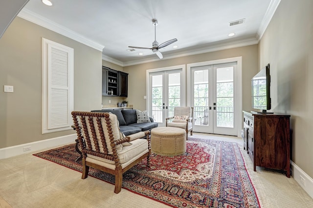 living room with light carpet, french doors, ceiling fan, and crown molding