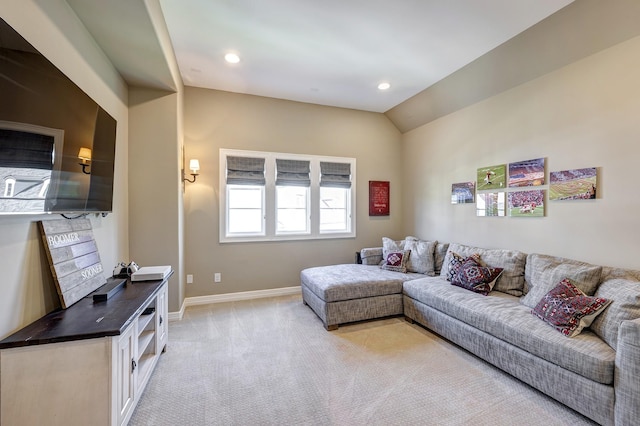 carpeted living room featuring vaulted ceiling