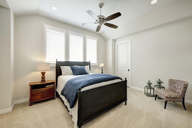 bedroom with ceiling fan, lofted ceiling, and light carpet