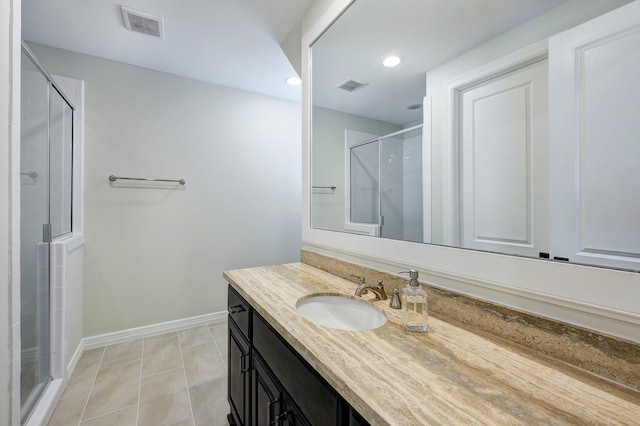 bathroom featuring tile patterned floors, vanity, and an enclosed shower