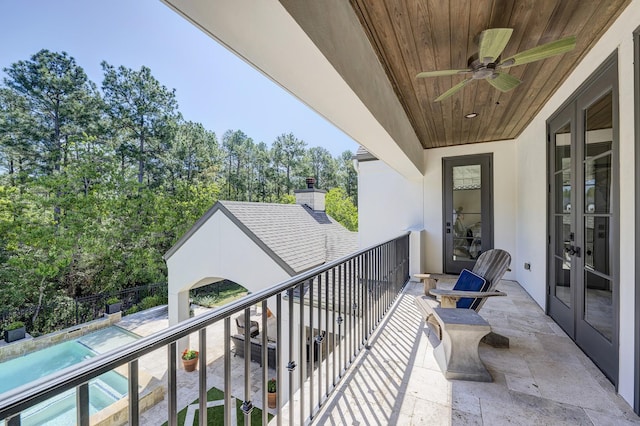 balcony with ceiling fan and french doors