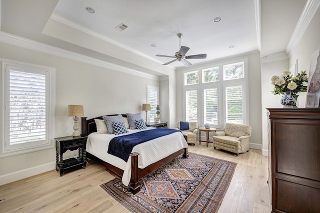 bedroom with ceiling fan, ornamental molding, and light hardwood / wood-style flooring