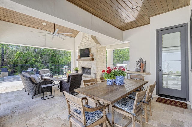 view of patio featuring an outdoor living space with a fireplace and ceiling fan