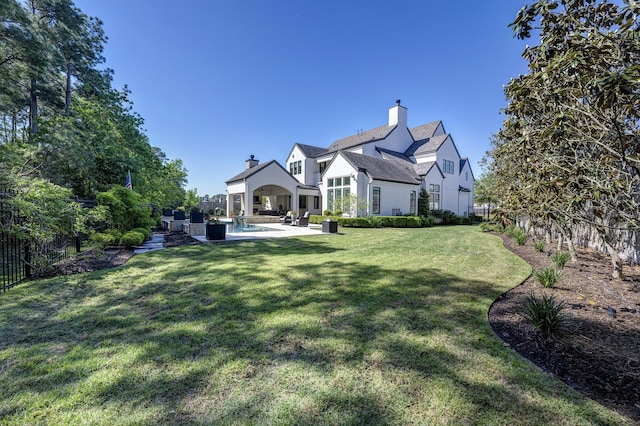 back of house with a yard, an outdoor hangout area, and a patio area