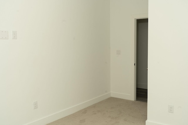 spare room featuring light colored carpet