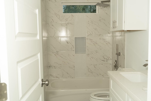 full bathroom with vanity, tiled shower / bath combo, and toilet