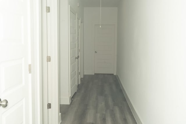 hallway with dark hardwood / wood-style flooring