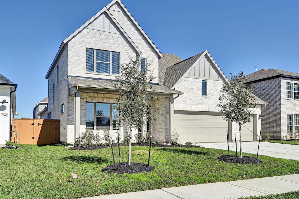 view of front facade featuring a garage and a front lawn