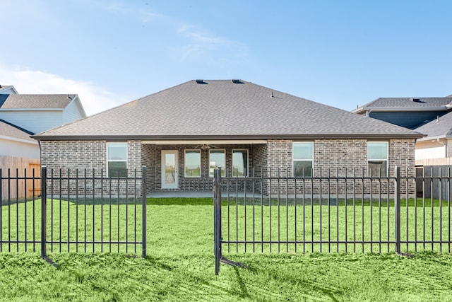 back of property with a yard and a patio