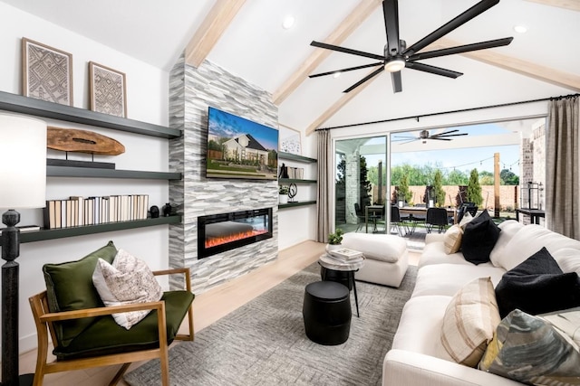 living room featuring vaulted ceiling with beams, ceiling fan, wood-type flooring, and a tiled fireplace