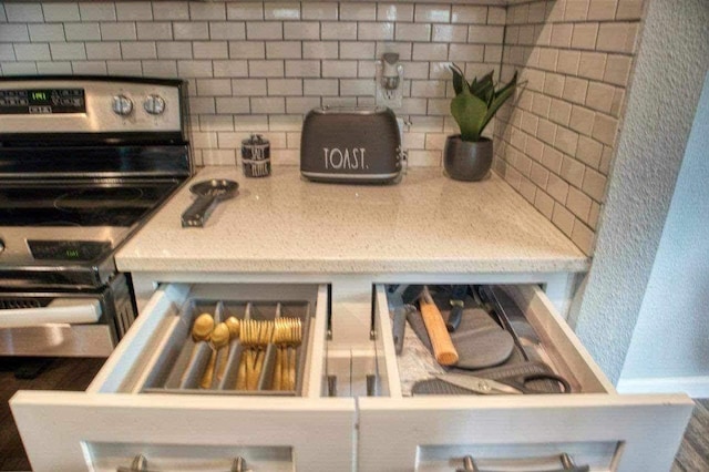 kitchen featuring backsplash and stainless steel electric range