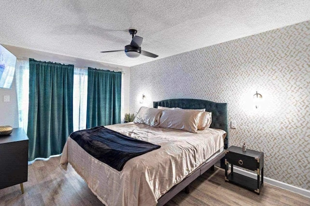 bedroom with ceiling fan and wood-type flooring