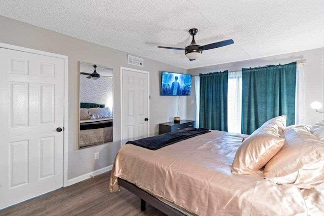 bedroom with hardwood / wood-style flooring, ceiling fan, and a textured ceiling